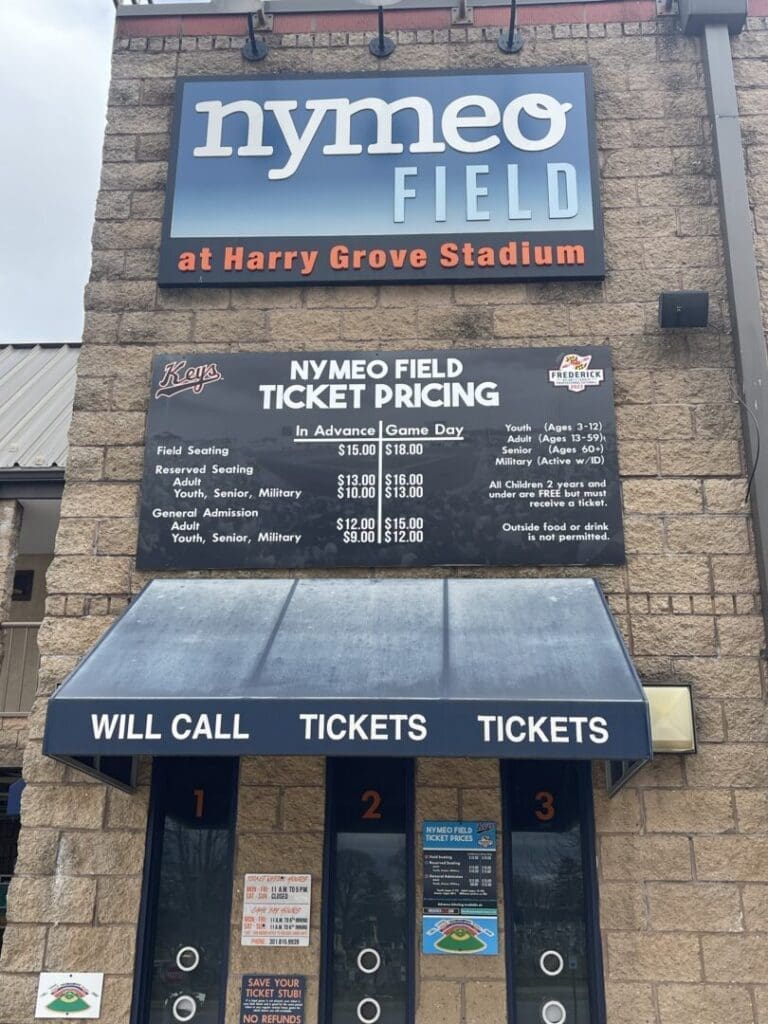 Entrance to Nymeo Field at Harry Grove Stadium Showing a Ticket Booth with Three Windows Labeled Will Call and Tickets a Sign Above Lists Ticket Prices and Mentions the Frederick Keys Schedule for Upcoming Games