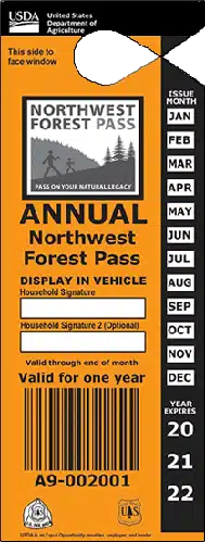 an Orange Annual Northwest Forest Pass from the Usda Perfect for Bend Hikes or Hikes Near Bend Oregon with Months Listed Vertically on the Right Display Instructions a Space for Signature and Barcodes Serial Number and Logos at the Bottom Valid for One Year