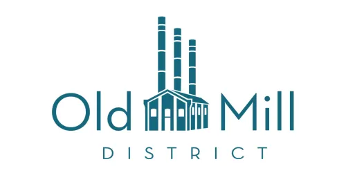 Logo for Old Mill District Featuring a Stylized Building with Three Tall Smokestacks in the Center Teal Blue on White with Old Mill and District Text Reflecting the Vibrant Spirit and Popular Bend Restaurants Nearby
