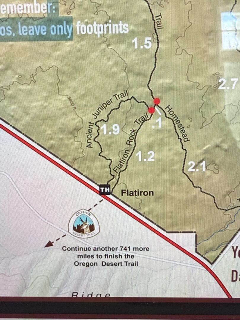 a Section of a Trail Map Shows the Flatiron Area with Labeled Trails Ancient Juniper Trail 19 Miles Flatiron Rock Trail 12 Miles and Homestead Trail 21 Miles a Note Says Continue Another 741 More Miles to Finish the Oregon Desert Trail